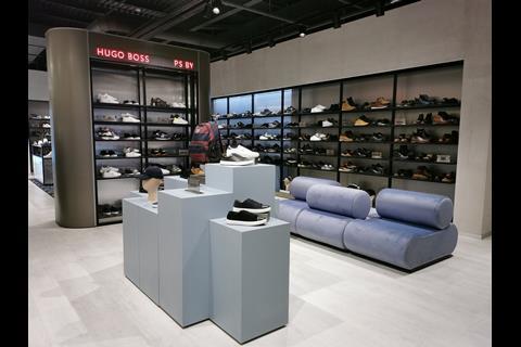 Digital screens pepper various departments of the store, including men's footwear.